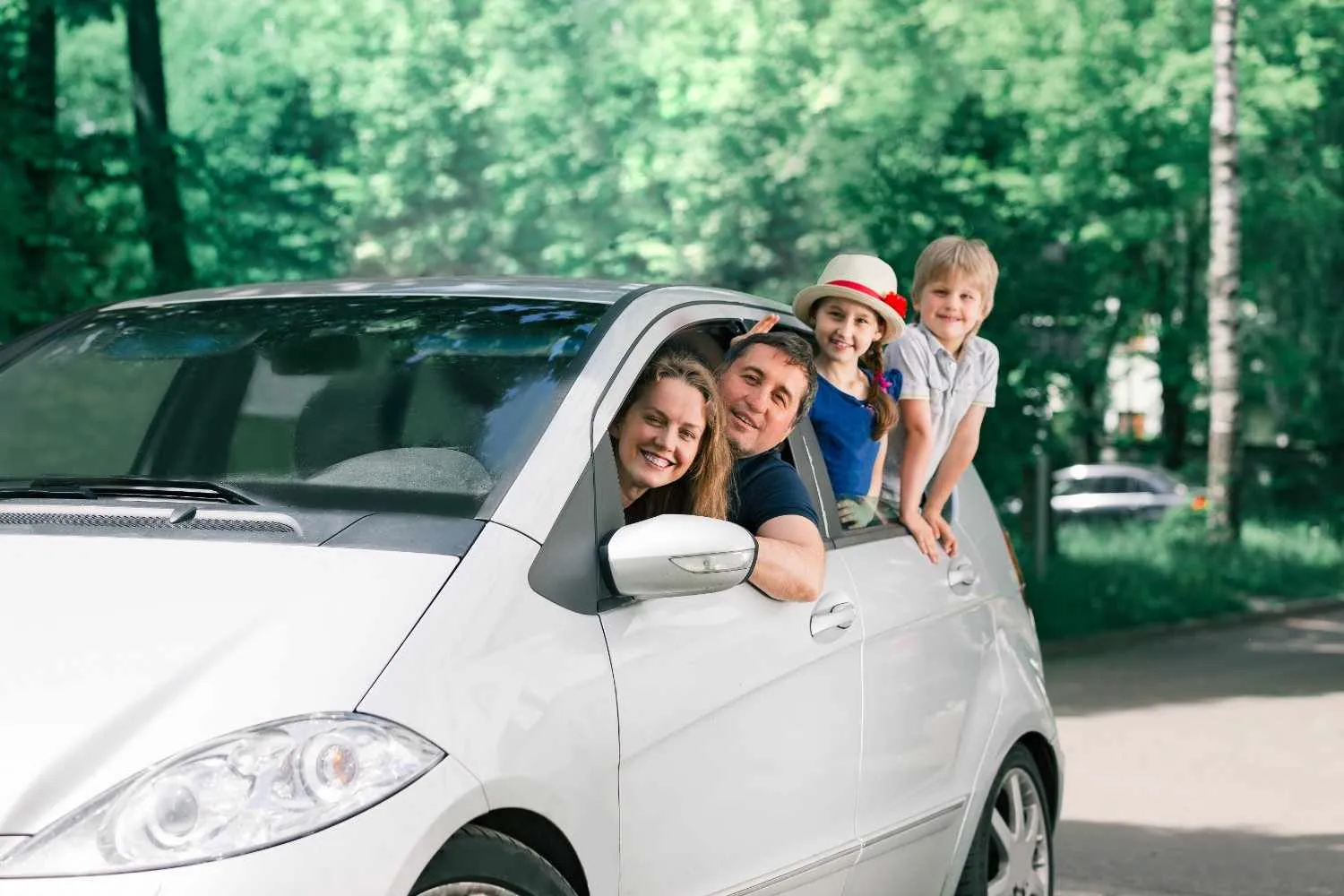 Family looking out of the windows of their car
